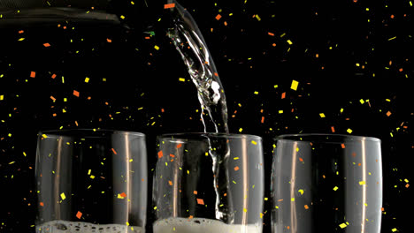 Animation-of-confetti-falling-over-champagne-pouring-into-three-glasses-on-black-background