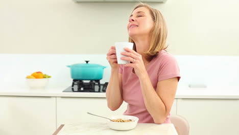 Mature-woman-having-coffee-at-breakfast