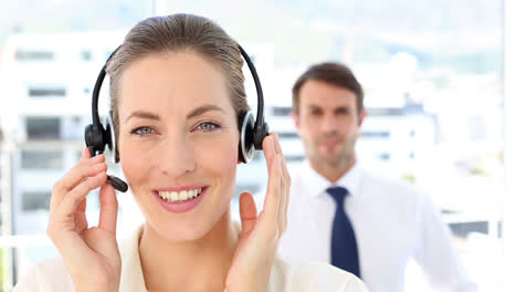 Call-centre-agent-speaking-with-colleague-behind-her