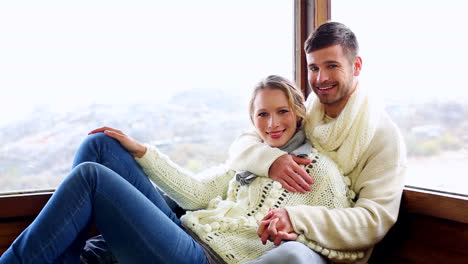 Cute-couple-relaxing-together-in-their-winter-cabin