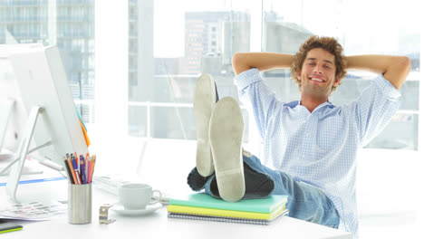 Relaxed-businessman-reclining-on-his-swivel-chair-