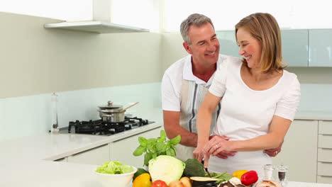 Mature-smiling-couple-making-healthy-dinner-together