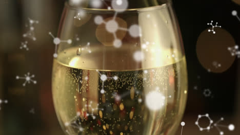 Animation-of-white-networks-moving-over-champagne-glass-on-black-background