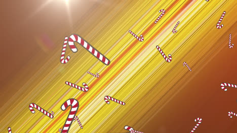 Multiple-candy-cane-icons-falling-against-spot-of-light-and-trails-light-on-yellow-background