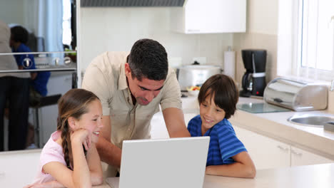 Father-using-the-laptop-with-his-children