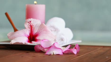 Towels-candles-and-pink-flower-by-the-pool