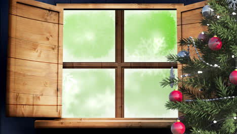 Christmas-tree-and-wooden-window-frame-against-snowflakes-falling-on-green-background