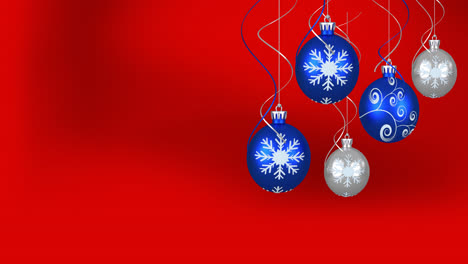 Animation-of-christmas-baubles-over-red-background