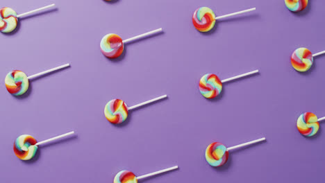 Video-of-rows-multicoloured-lollipops-on-blue-background