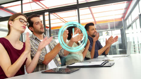 Animation-of-clock-over-diverse-male-and-female-business-colleagues-clapping-hands-in-office