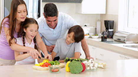 Mother-showing-her-children-how-to-slice-vegetables