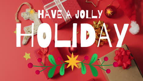 Animation-of-have-a-jolly-holiday-text-over-christmas-decoration-and-gifts