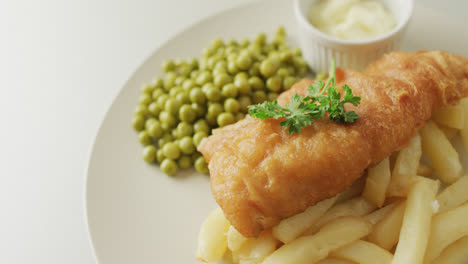Video-of-fish,-chips-and-peas-on-plate-with-dip