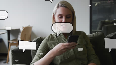 Animation-of-speech-bubbles-over-caucasian-businesswoman-using-smartphone