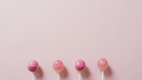 Video-of-pink-lollipops-on-pink-background