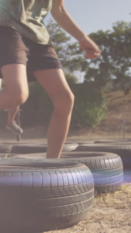 Animation-of-light-spots-over-diverse-schoolchildren-exercising-on-obstacle-course