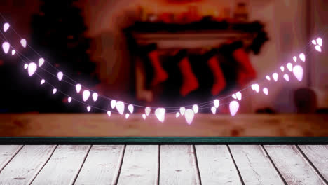 Glowing-pink-fairy-light-decoration-hanging-over-textured-wooden-plank