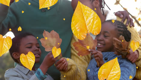 Animation-of-autumn-leaves-falling-over-african-american-parents-with-son-and-daughter-in-park