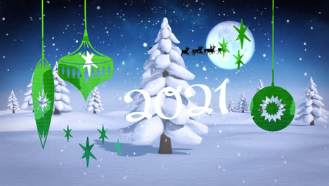 2021-text-and-christmas-hanging-decorations-against-snow-falling-over-winter-landscape