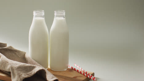 Video-of-glass-bottles-of-milk-on-white-background