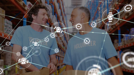 Animation-of-network-of-connections-with-icons-over-diverse-volunteers-in-warehouse