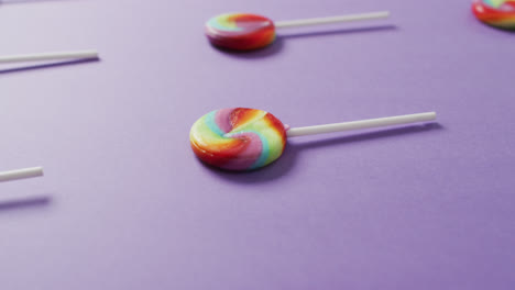 Video-of-rows-multicoloured-lollipops-on-blue-background