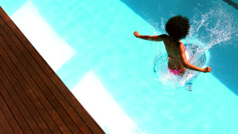 Woman-in-pink-bikini-jumping-into-swimming-pool