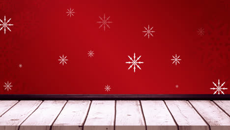 Animation-of-falling-snowflakes-on-red-background-and-wooden-floor