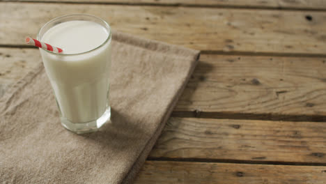 Video-of-glass-of-fresh-milk-on-wooden-background