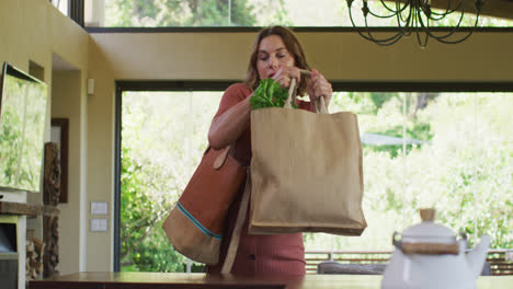 Tired-caucasian-pregnant-woman-returning-home-from-shopping-with-heavy-bag-of-vegetables