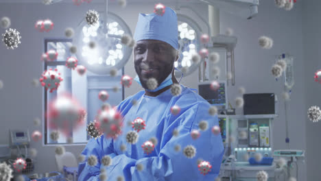 Animation-of-covid-19-cells-over-smiling-african-american-male-surgeon
