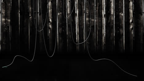 Animation-of-hanging-cables-and-wooden-boards-on-dark-background
