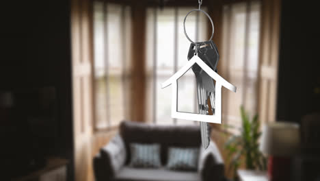 Animation-of-silver-key-with-house-shape-over-empty-room