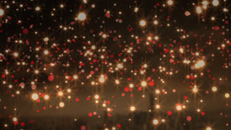 Animation-of-yellow-and-red-christmas-flickering-spots-over-cityscape-in-background