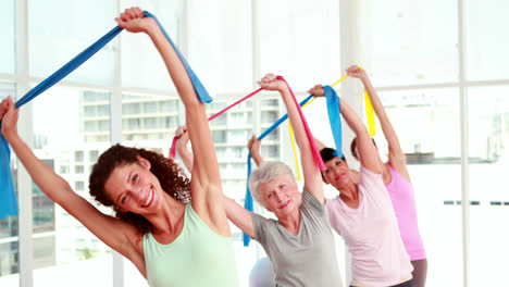 Women-stretching-resitance-bands-at-a-fitness-class