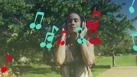 Animation-of-note-icons-over-biracial-woman-listening-to-music-with-scooter-in-park