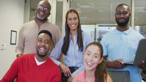 Portrait-of-diverse-male-and-female-business-colleagues-smiling-in-office