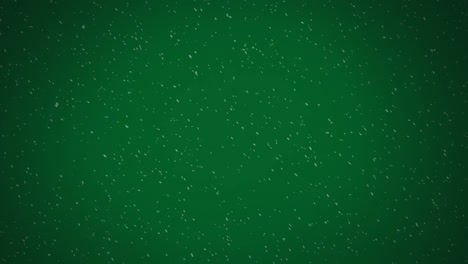 Digital-animation-of-snow-and-white-particles-falling-against-green-background