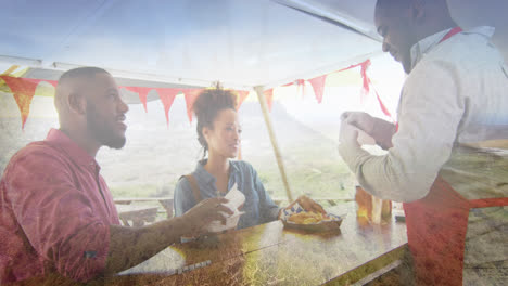 Composite-of-happy-african-american-couple-buying-takeaway-food,-and-mountain-countryside