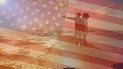 Animation-of-flag-of-united-states-of-america-over-couple-walking-on-beach