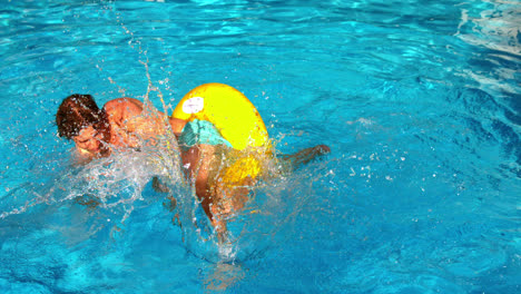 Young-man-splashing-and-having-fun-in-swimming-pool