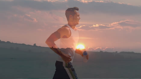 Composite-of-caucasian-man-jogging-and-sunset-sky-over-countryside