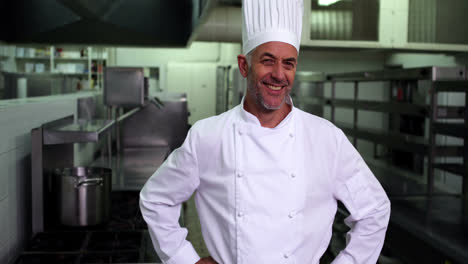 Head-chef-smiling-at-camera-with-hands-on-hips