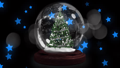 Shooting-star-over-christmas-tree-in-a-snow-globe-against-multiple-blue-stars-icons-floating