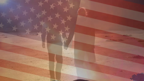 Animation-of-flag-of-united-states-of-america-over-couple-walking-on-beach