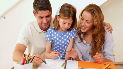 Cute-parents-and-daughter-colouring-together