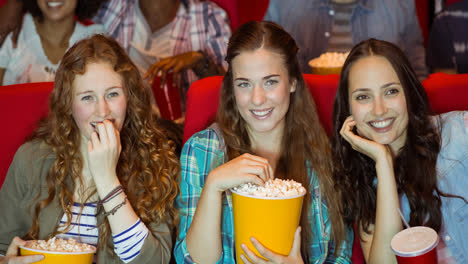 Animation-of-happy-diverse-group-of-people-eating-popcorn-in-cinema