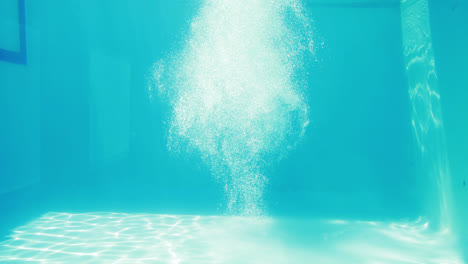 Man-diving-into-blue-swimming-pool