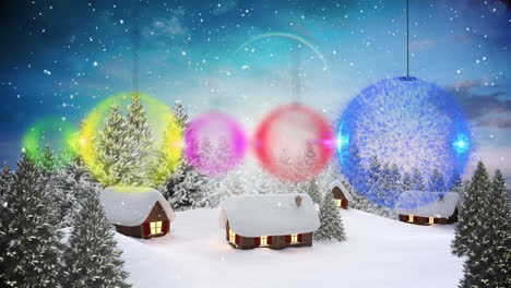 Multiple-bauble-decorations-hanging-against-snow-falling-over-winter-landscape