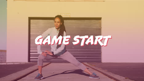 Game-start-text-banner-against-african-american-fit-woman-performing-stretching-exercise-outdoors